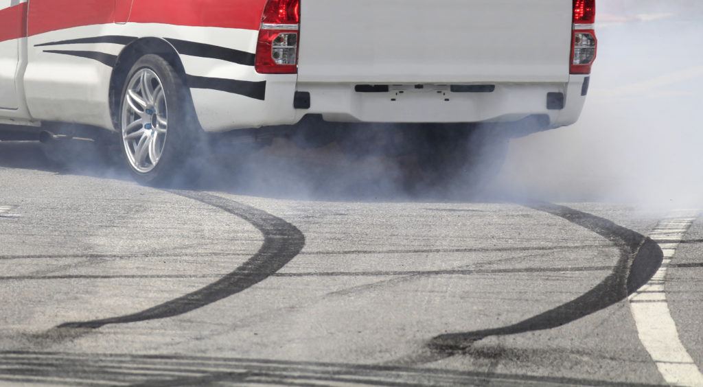 Emergency braking wheel with smoke on the highway and skidding.